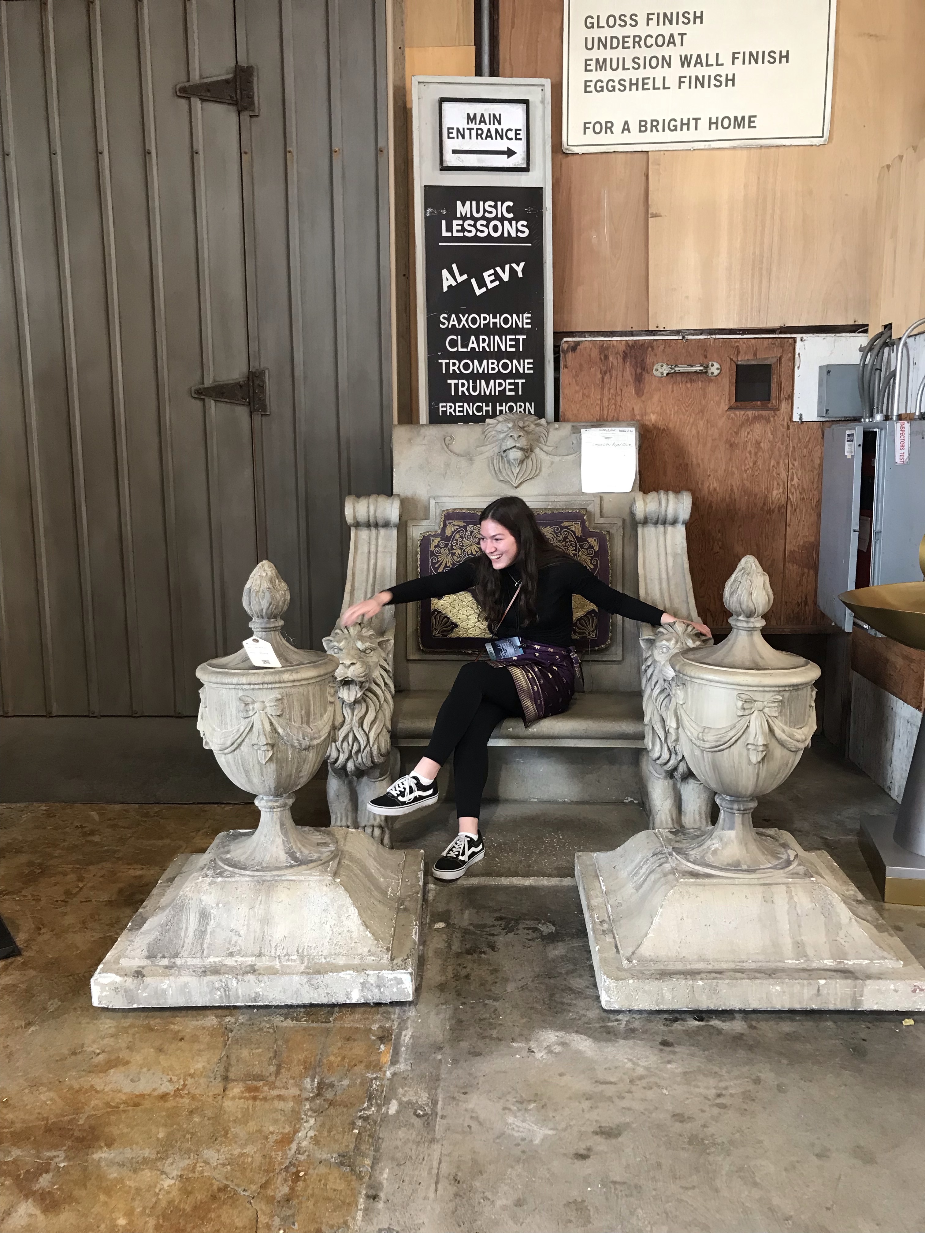 Girl sitting in Gladiator movie throne prop